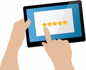 Illustration showing two hands holding a tablet. One hand is holding the tablet while the other points to a screen displaying a five-star rating. The background of the tablet screen is blue with white at the center showcasing the stars.