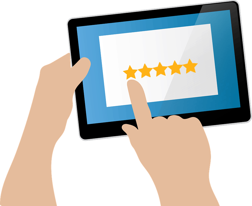 An illustration of a person using a tablet. The tablet screen shows a five-star rating system, with the individual's finger touching one of the stars, possibly to select or give a rating. The image background is transparent, with focus on the tablet and hands.
