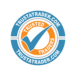A circular logo with a blue outer ring featuring the text "TRUSTATRADER.COM" at the top and bottom. Inside, a smaller orange circle contains a blue check mark over the words "TRUSTED TRADERS".