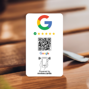 A Google Smart Review Card Multi Packs - Free Delivery is shown with the Google logo and five gold stars beneath it. Below the stars is a QR code followed by the Google logo. At the bottom, there's an icon of a hand holding a phone with the text “NFC” and “Powered by review.cards.” The card is set on a wooden surface.