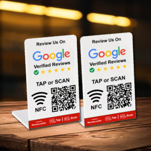 Two tabletop signs with the text "Review Us On Google Verified Reviews." Each sign displays five stars, a checkmark in a green circle, a QR code, and the instructions "TAP or SCAN NFC." The 2 Google Tap or Scan Stands - FREE Delivery promote using NFC or QR code for leaving reviews.