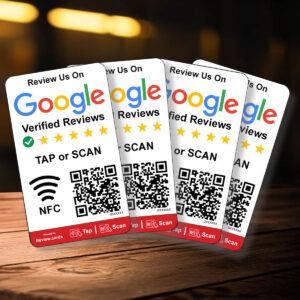 Four 4 Google Smart Review Cards are displayed on a wooden surface, each featuring the Google logo, a 5-star rating graphic, "Review Us On Google Verified Reviews," QR codes, and NFC symbols for tap or scan functionality. The cards are slightly tilted and staggered for a dynamic layout.